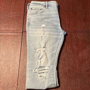 Distressed Blue [AE] stacked skinny jeans.